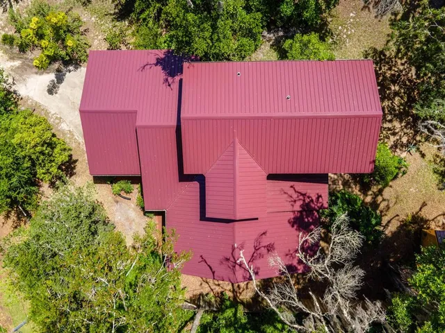 an aerial view of a house with a yard