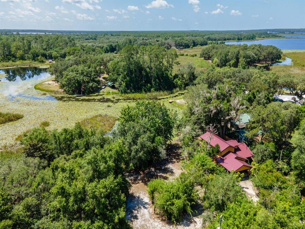 23610 Northeast 154th Place Road Fort McCoy, FL 32134 - Photo 37 of 44 an aerial view of residential house with outdoor space and swimming pool