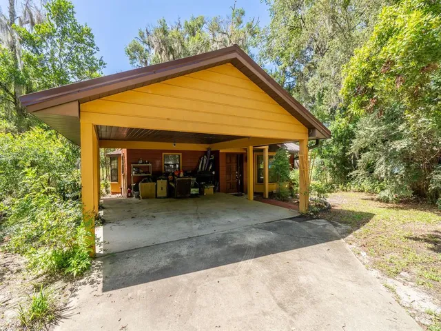 a view of a house with backyard and sitting area