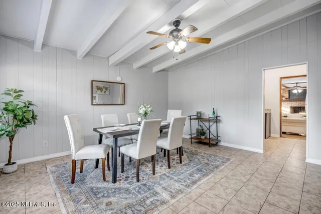 a view of a dining room with furniture and a chandelier