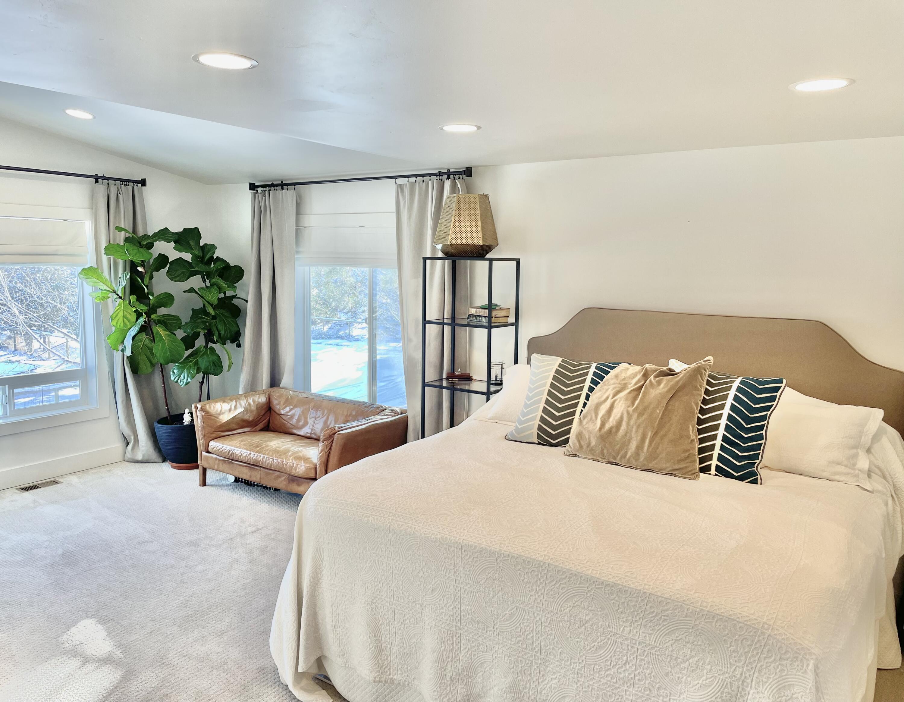 63210 Overtree Road Bend, OR 97701 - Photo 5 of 9 a bedroom with a bed and a potted plant