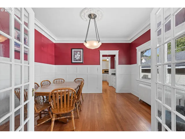 a view of a dining room with furniture and wooden floor