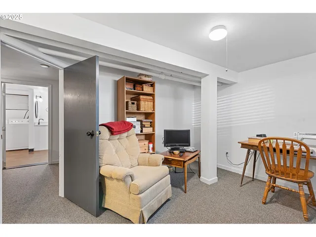 a living room with furniture a flat screen tv and a dining table