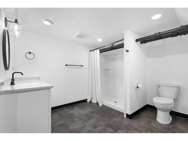 a bathroom with a sink toilet and shower