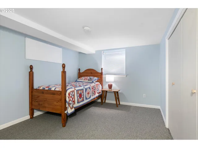 a bedroom with a bed and a lamp