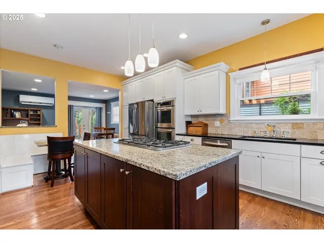 a kitchen with a stove a counter space and a sink