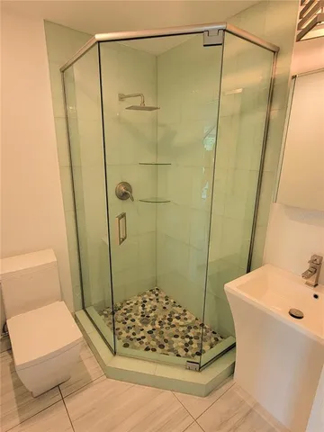 a bathroom with a shower and a sink