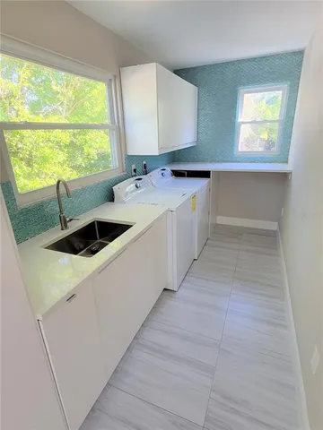a kitchen with a sink and large window