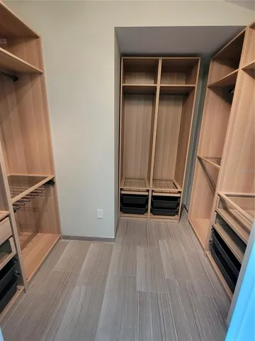 an empty room with wooden floor and white walls