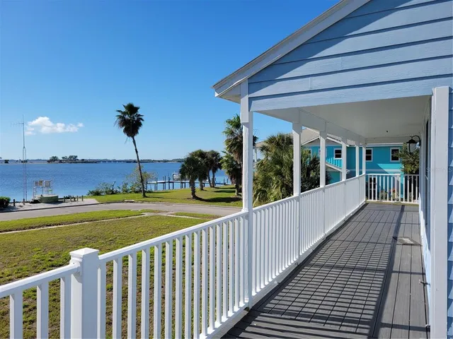 a view of a balcony with dining table and chairs with wooden floor