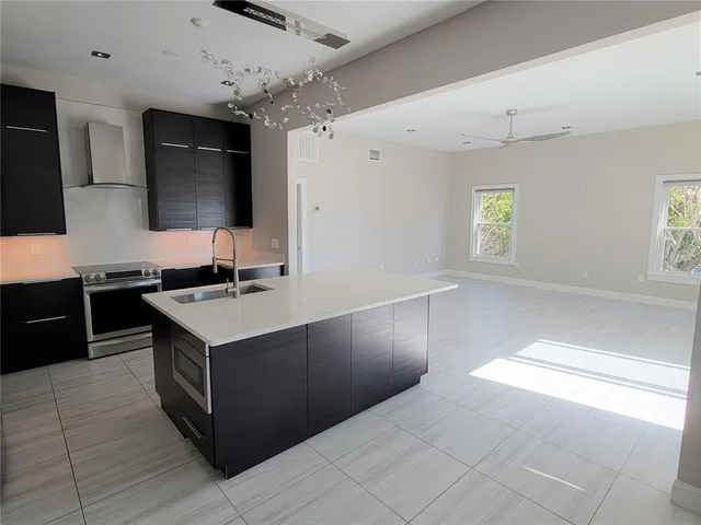 a kitchen with stainless steel appliances granite countertop a stove and a sink