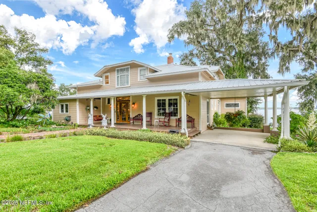 a living room with fireplace furniture and a window