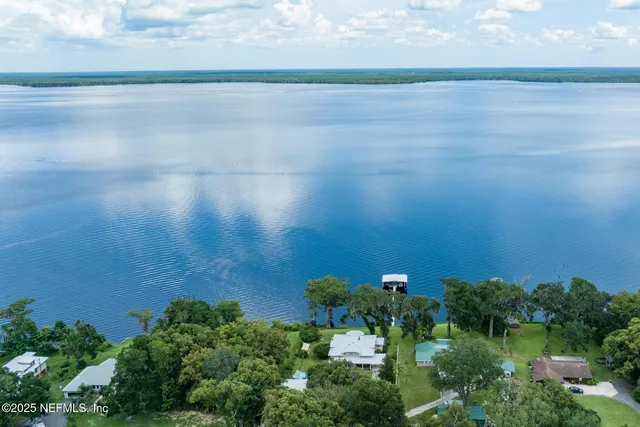 an aerial view of a houses with a yard