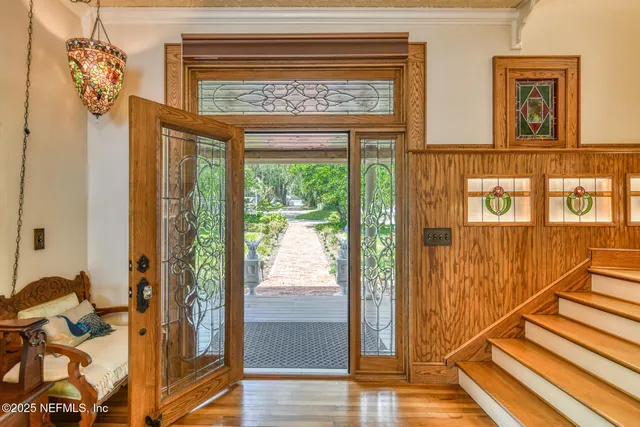 a bedroom with a bed and a lamp on dresser