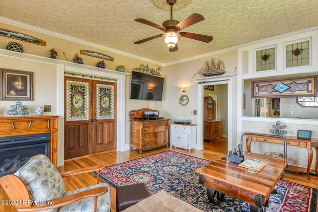 a bed room with a bed television and a large window