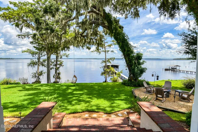 a kitchen with stainless steel appliances granite countertop a stove a sink dishwasher a stove and a refrigerator with wooden floor