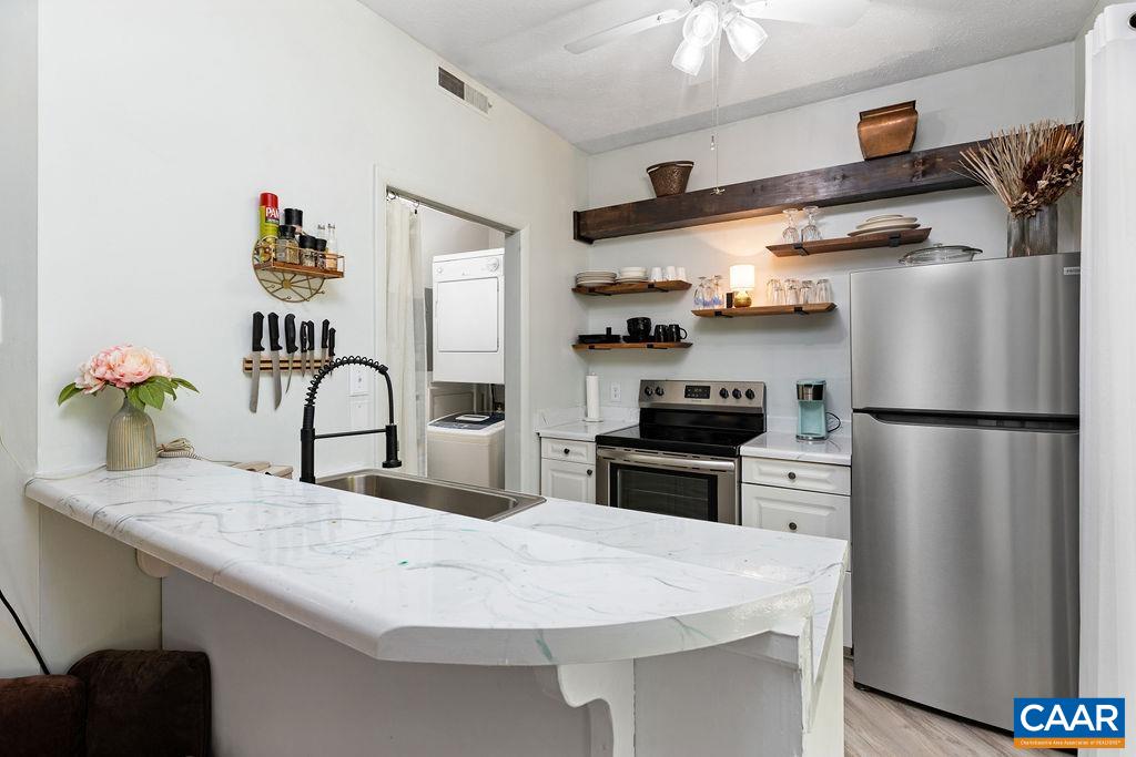 490 3 Ridges Roseland, VA 22967 - Photo 15 of 27 a kitchen with stainless steel appliances granite countertop a refrigerator a stove and a sink with wooden floor