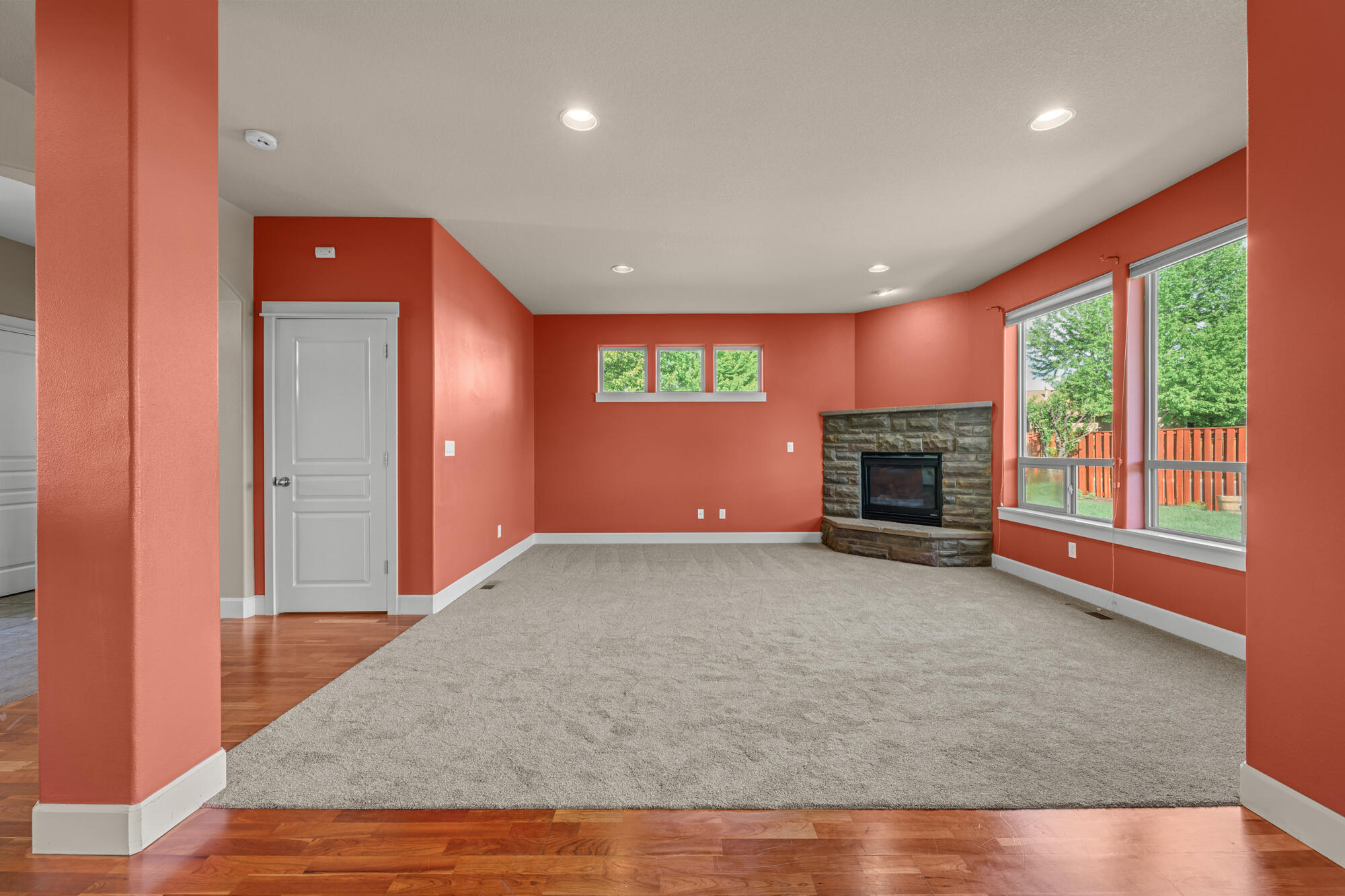 1402 Northeast Hudspeth Road Prineville, OR 97754 - Photo 8 of 36 an empty room with windows and fireplace