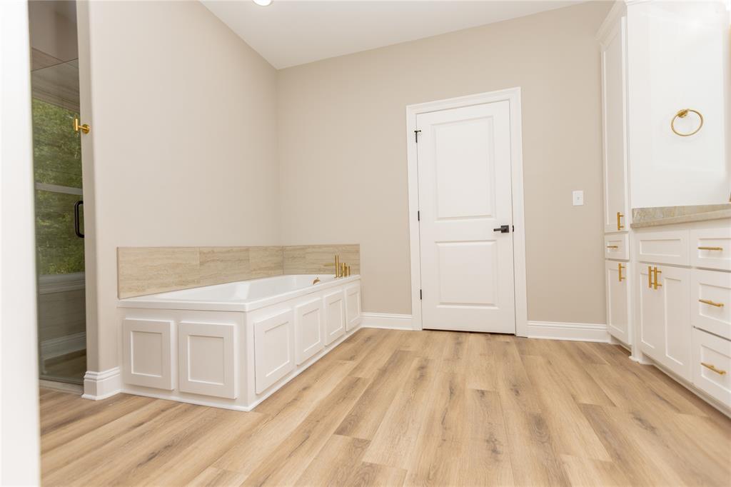 1025 VOSS Road Stonewall, LA 71078 - Photo 6 of 13 a view of a kitchen with white cabinets and wooden floor