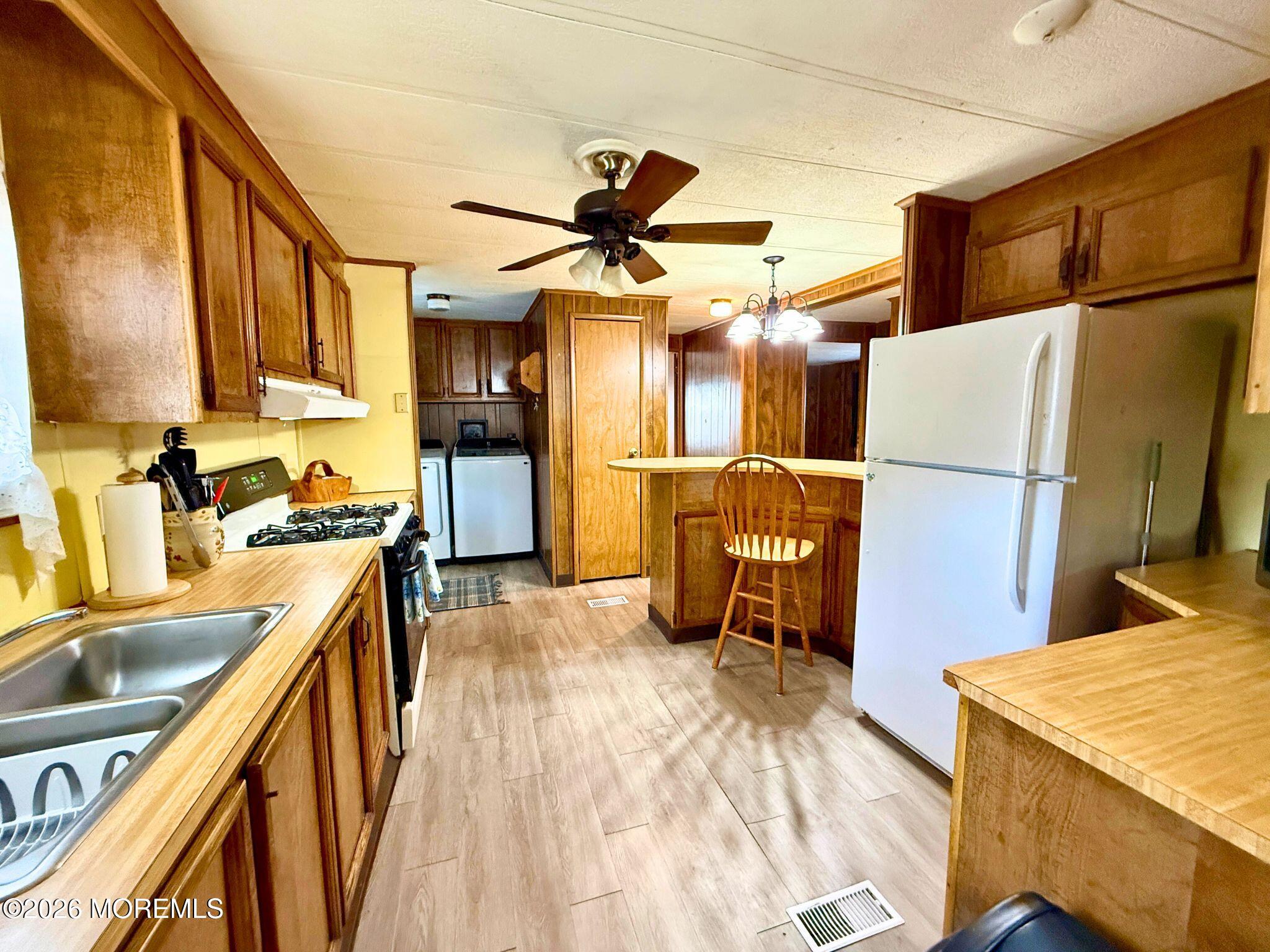 33 Judith Way Jackson, NJ 08527 - Photo 7 of 28 a kitchen with stainless steel appliances granite countertop a sink and a refrigerator