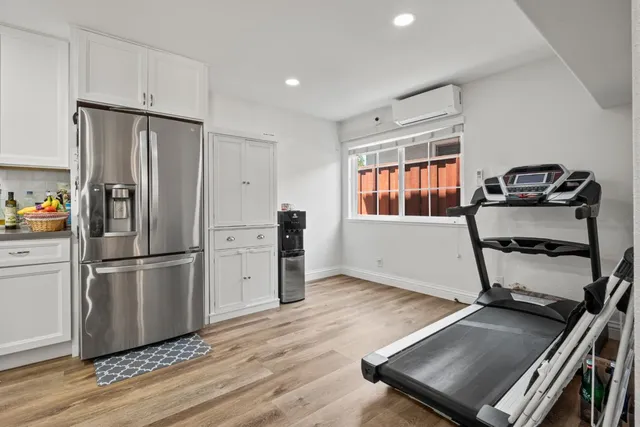 a kitchen with a refrigerator and windows