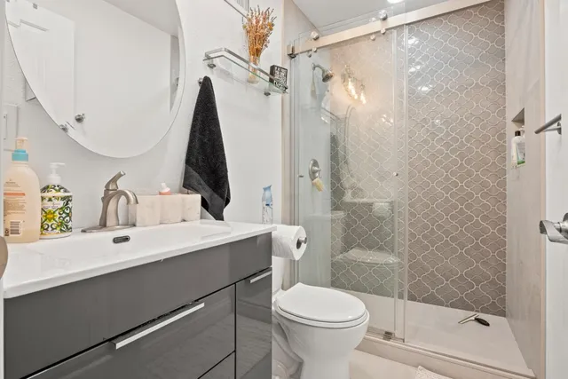 a bathroom with a sink toilet and shower