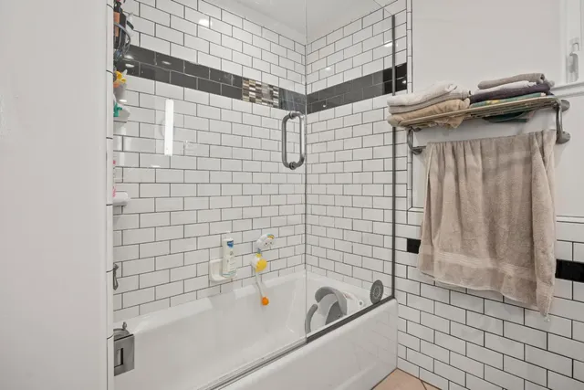 a bathroom with a shower and a sink