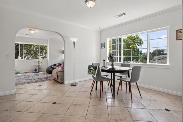 a view of a dining room with furniture and a potted plant