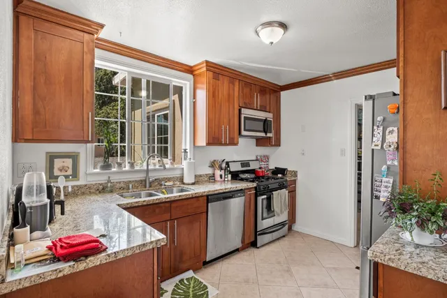 a kitchen that has a sink and a stove in it