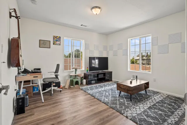 a living room with furniture a window and a flat screen tv
