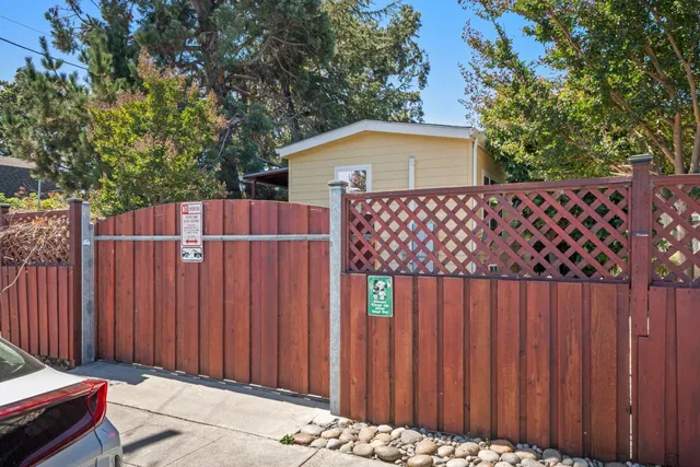 a backyard of a house with wooden fence
