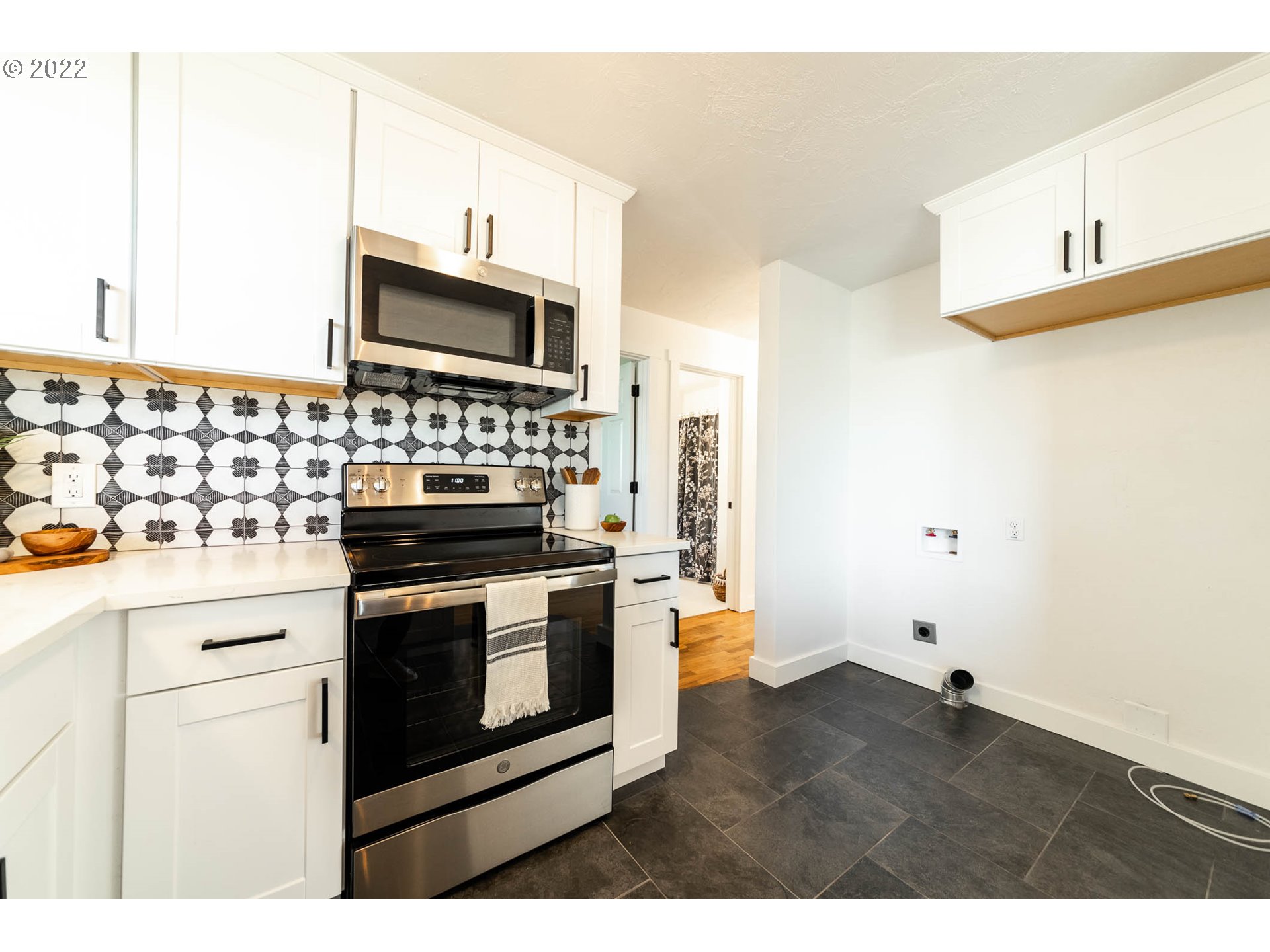 1218 N Street Springfield, OR 97477 - Photo 12 of 27 a kitchen with stainless steel appliances a stove microwave and refrigerator