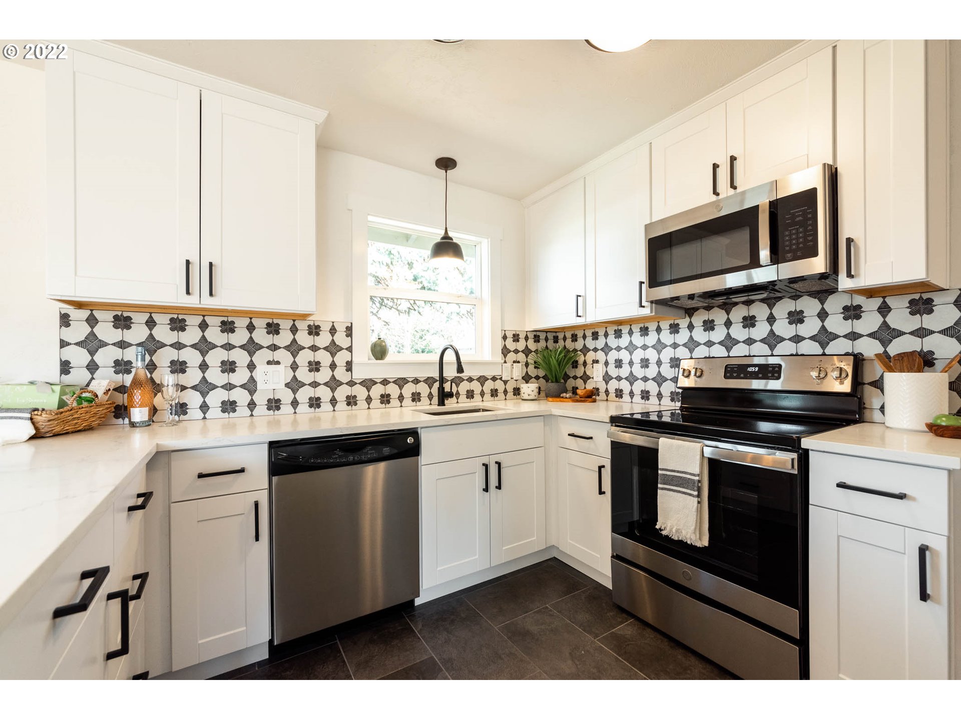 1218 N Street Springfield, OR 97477 - Photo 8 of 27 a kitchen with stainless steel appliances a sink stove and microwave