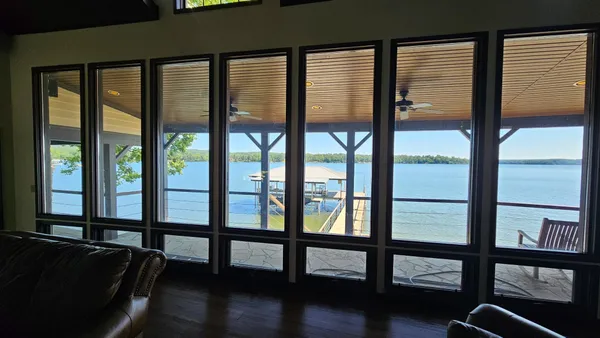 a view of empty room with window and wooden floor
