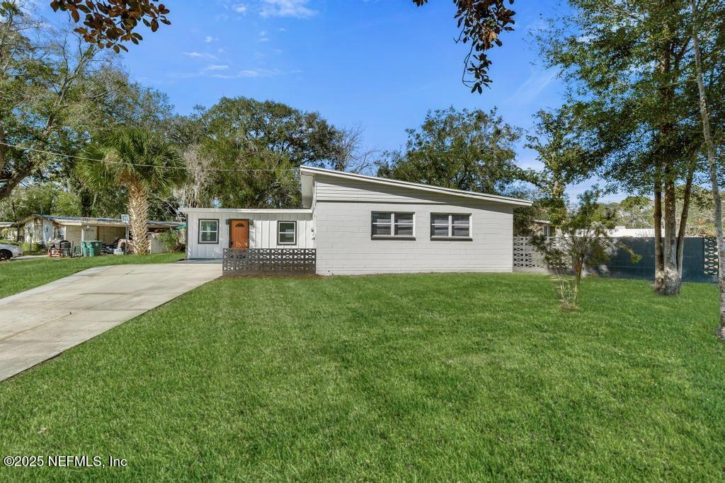 7214 Hernando Road Jacksonville, FL 32217 - Photo 1 of 21 a view of a house with backyard and a tree