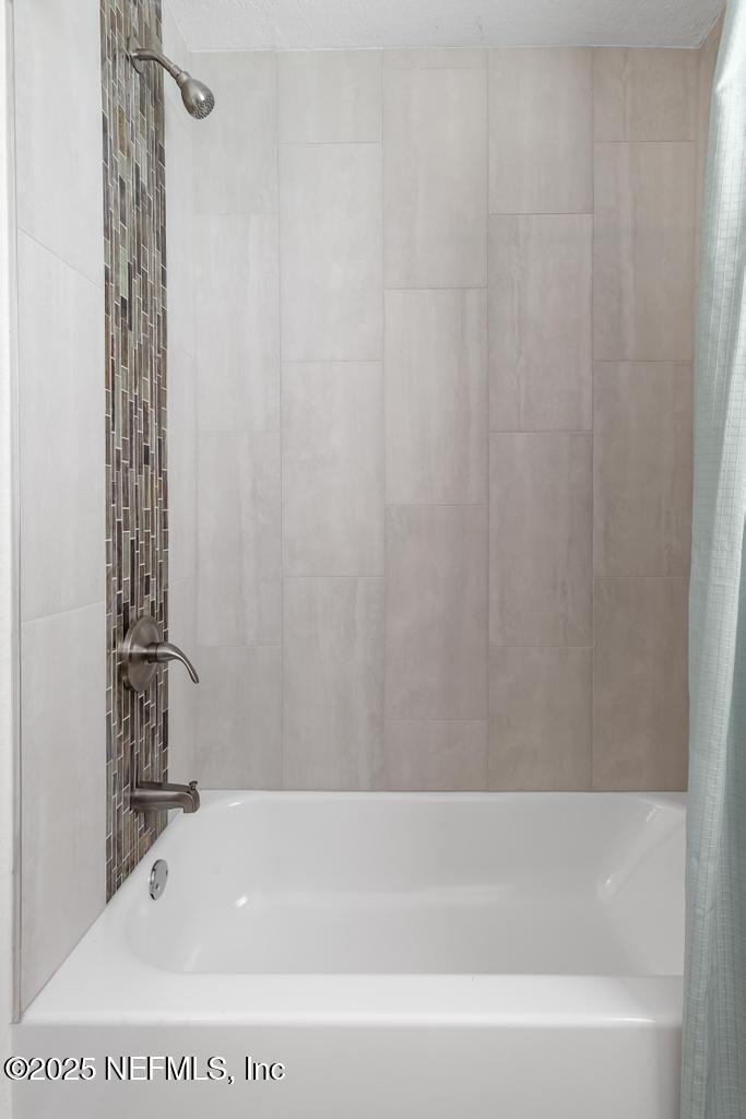 7214 Hernando Road Jacksonville, FL 32217 - Photo 13 of 21 a bathroom with a bathtub and shower