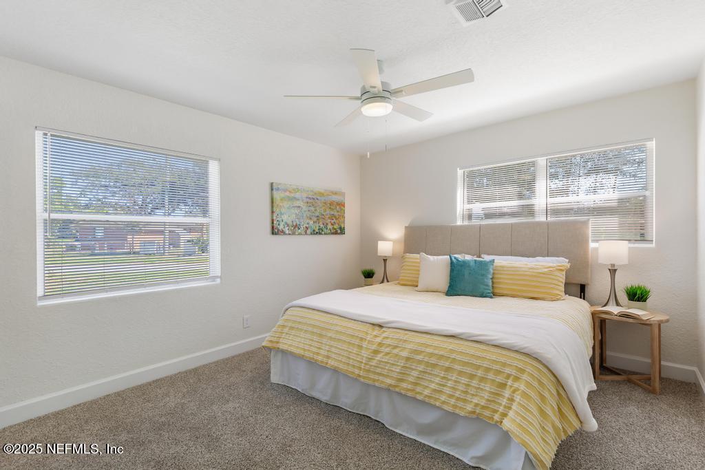 7214 Hernando Road Jacksonville, FL 32217 - Photo 15 of 21 a bedroom with a bed wooden floor and window