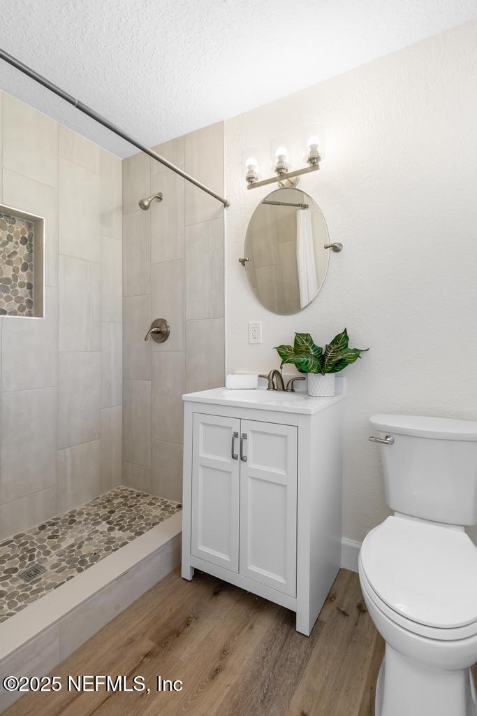 7214 Hernando Road Jacksonville, FL 32217 - Photo 16 of 21 a bathroom with a sink a mirror and a toilet