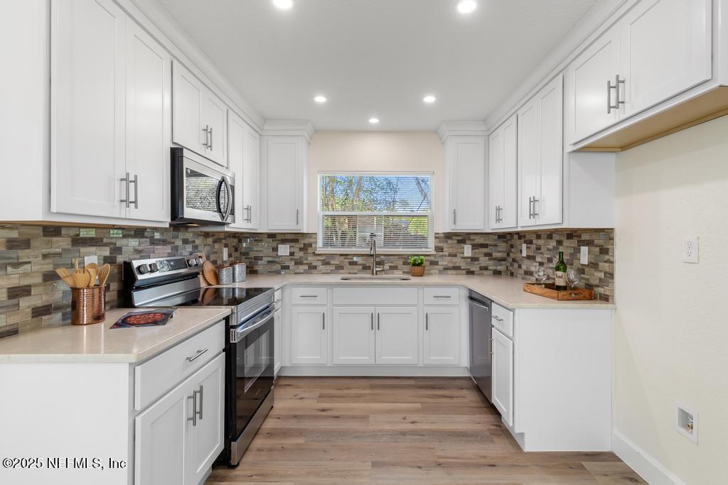 7214 Hernando Road Jacksonville, FL 32217 - Photo 6 of 21 a kitchen with granite countertop white cabinets and white appliances