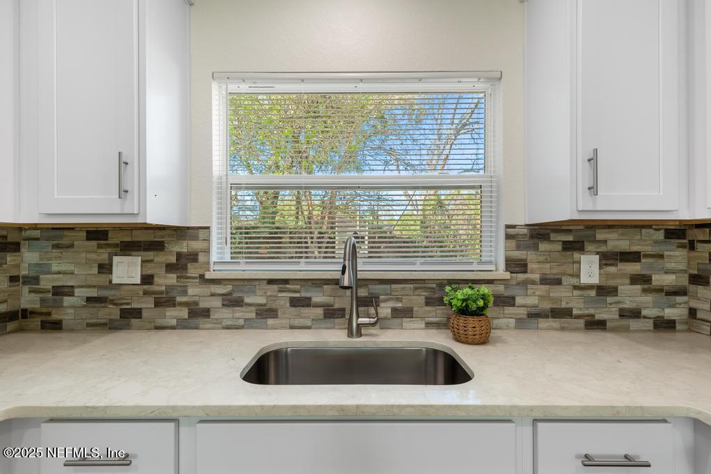 7214 Hernando Road Jacksonville, FL 32217 - Photo 7 of 21 a kitchen with sink a window and cabinets