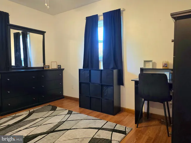 a bedroom with a dresser and a mirror