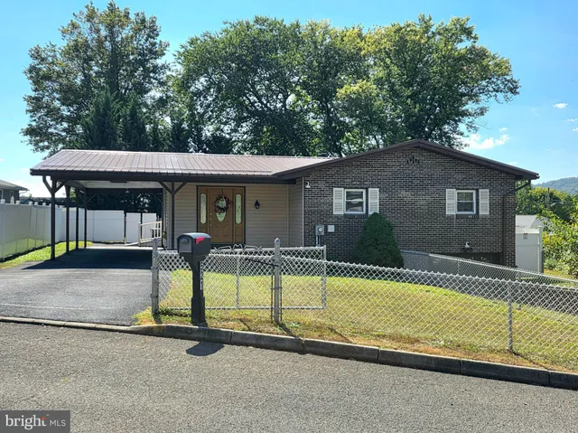 a view of a house with swimming pool and sitting area