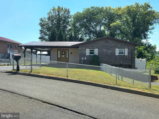 a view of swimming pool with large trees