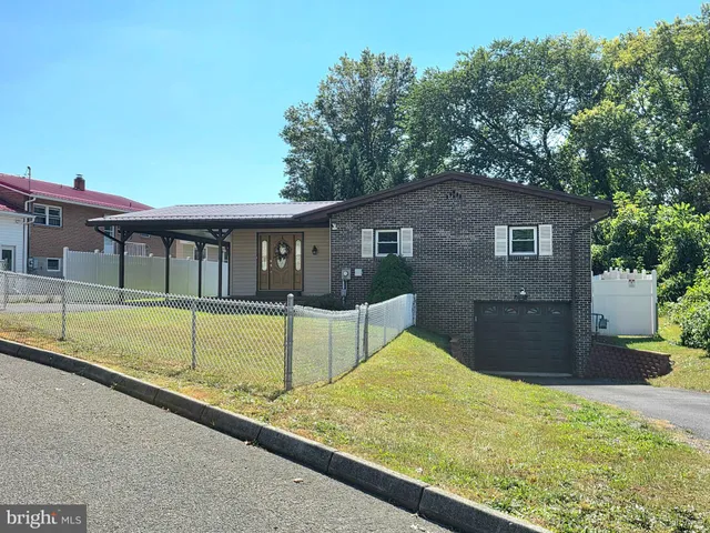 a house view with swimming pool in front of it