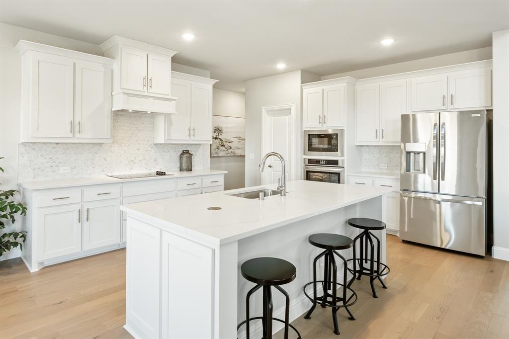 817 Rusty Run Drive Midlothian, TX 76065 - Photo 13 of 40 a kitchen with appliances a sink and cabinets