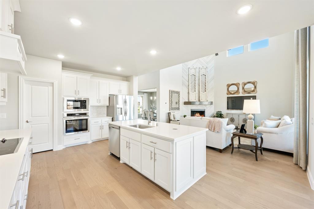817 Rusty Run Drive Midlothian, TX 76065 - Photo 18 of 40 a large white kitchen with stainless steel appliances