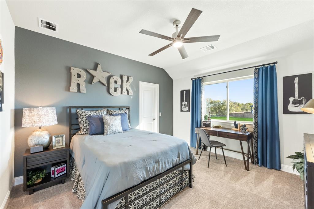 817 Rusty Run Drive Midlothian, TX 76065 - Photo 35 of 40 a bedroom with a bed and a large window