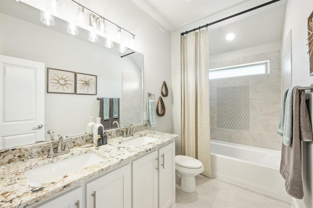 817 Rusty Run Drive Midlothian, TX 76065 - Photo 36 of 40 a bathroom with a granite countertop sink toilet and shower