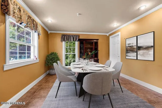a dining room with furniture window and wooden floor