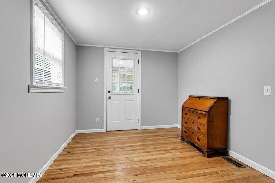 150 Easy Street Howell, NJ 07731 - Photo 21 of 23 an empty room with wooden floor cabinet and windows